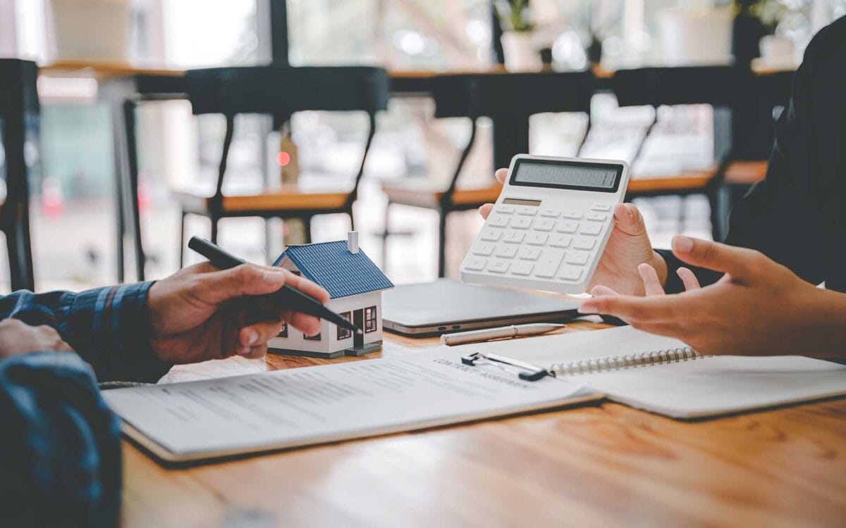 Person holding a calculator facing another person