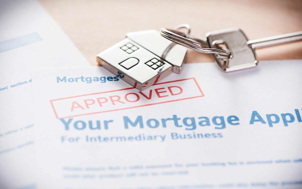 House key and approved mortgage application papers